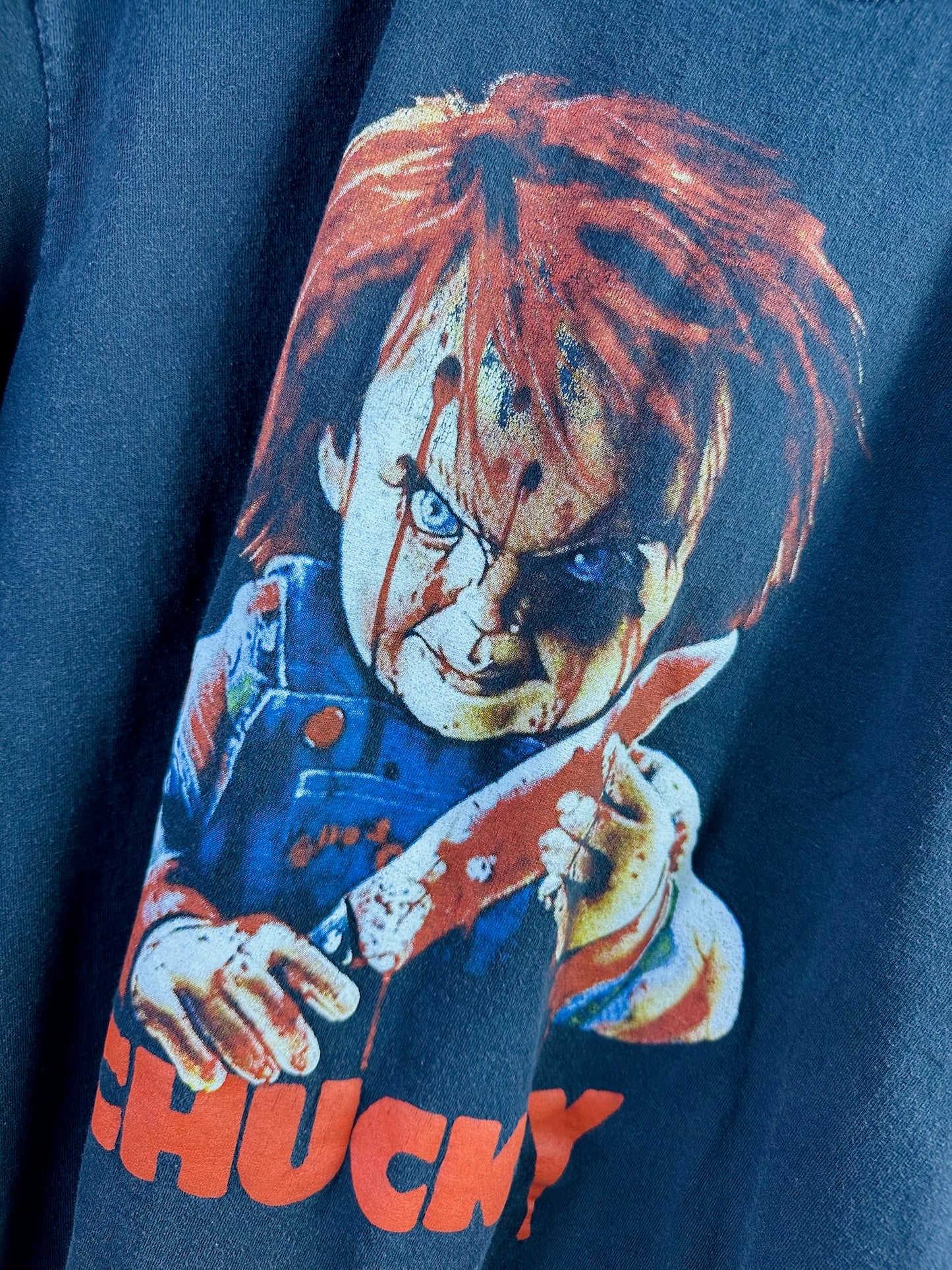 ( L ) Chucky Tee